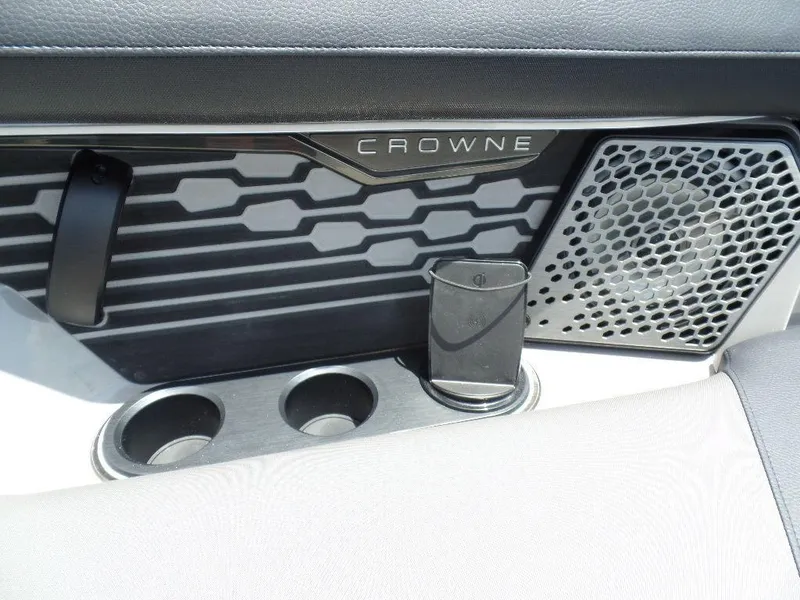 Slide: The Image of 2025 Harris Crowne 250 interior detail with speaker and cup holders. - 11