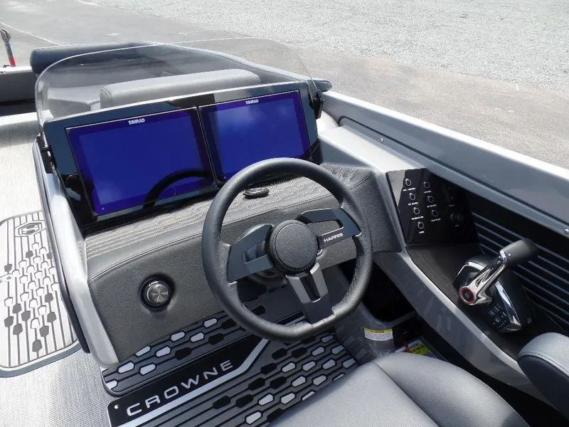 Slide: The Image of 2025 Harris Crowne 250 boat dashboard with dual screens and steering wheel. - 20
