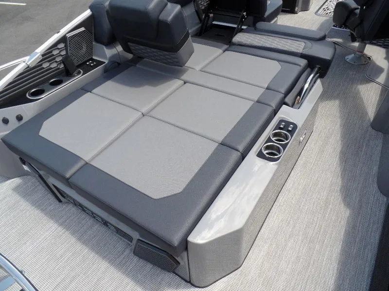 Slide: The Image of 2025 Harris Crowne 250 boat interior with gray seating and cup holders. - 24