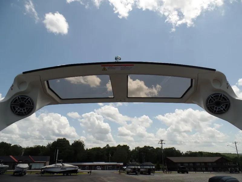 Slide: The Image of 2025 Harris Crowne 250 boat canopy with speakers under a cloudy sky. - 29