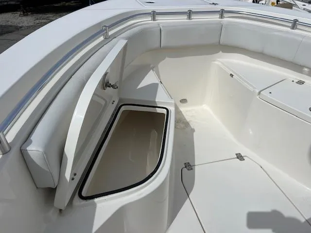 Slide: The Image of 2021 Cobia 237 Center Console boat with open storage compartment. - 10