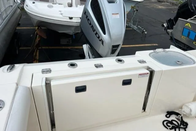Slide: The Image of 2021 Cobia 237 Center Console boat with Honda outboard motor. - 12