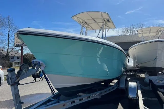 Slide: The Image of 2021 Cobia 237 Center Console boat on trailer, side view. - 2