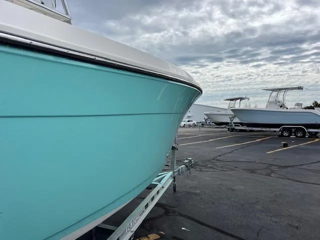 Slide: The Image of 2021 Cobia 237 Center Console boat on trailer in parking lot. - 3