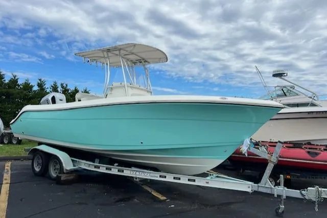 Slide: The Image of 2021 Cobia 237 Center Console boat on trailer under cloudy sky. - 4
