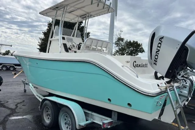 Slide: The Image of 2021 Cobia 237 Center Console boat with Honda engine on trailer. - 6
