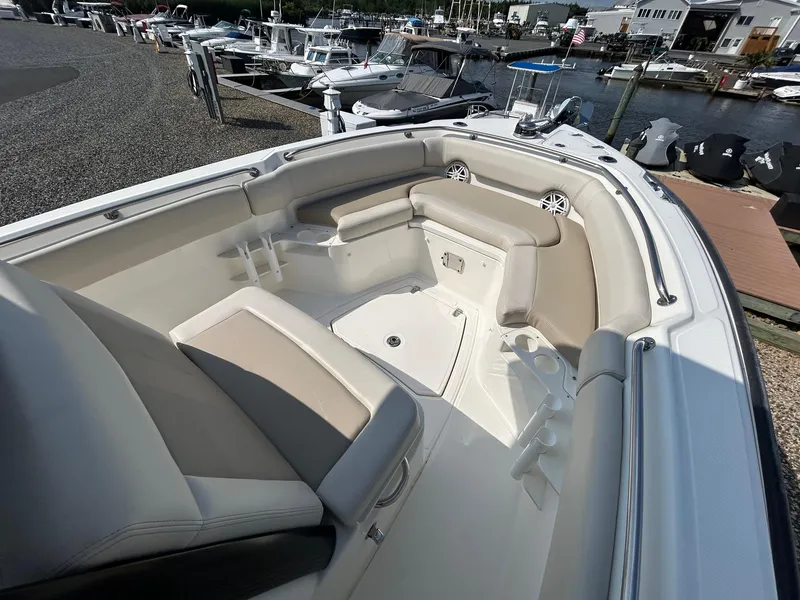 Slide: The Image of 2024 Boston Whaler 230 Outrage boat stern with Mercury outboard motor. - 11