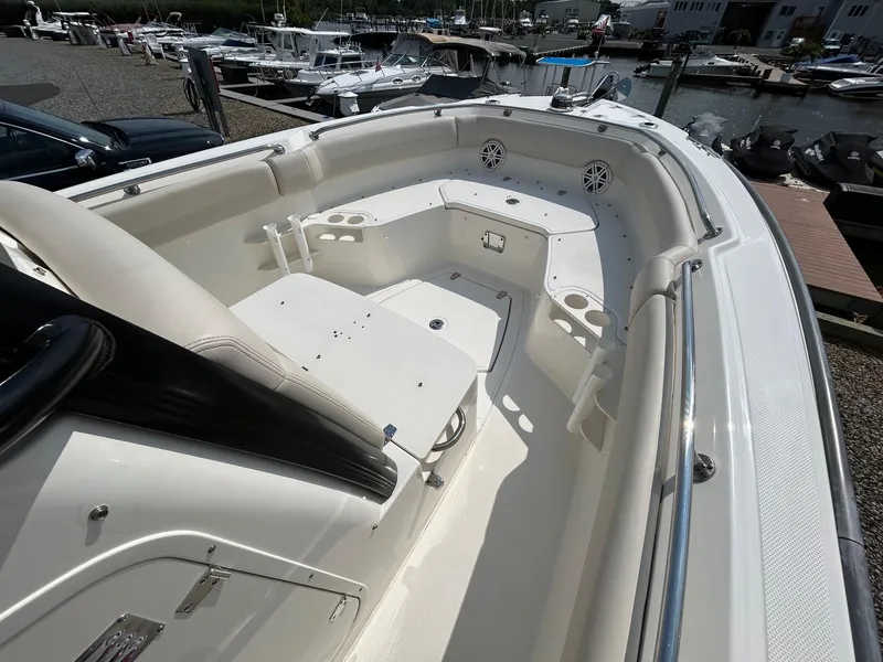 Slide: The Image of 2024 Boston Whaler 230 Outrage boat console with steering wheel and controls. - 14