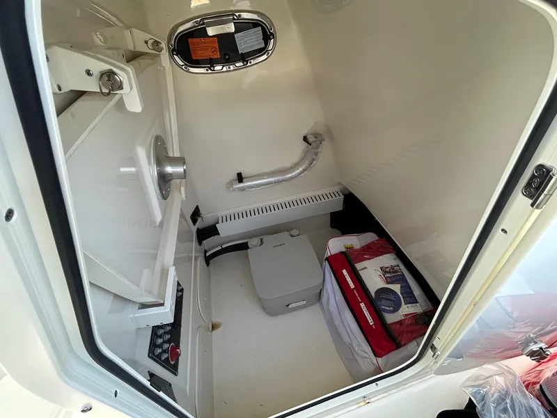 Slide: The Image of 2024 Boston Whaler 230 Outrage boat interior with seating and storage. - 15