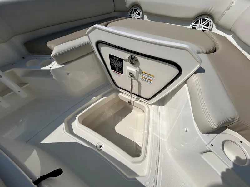 Slide: The Image of 2024 Boston Whaler 230 Outrage boat interior with cushioned seating and cup holders. - 16