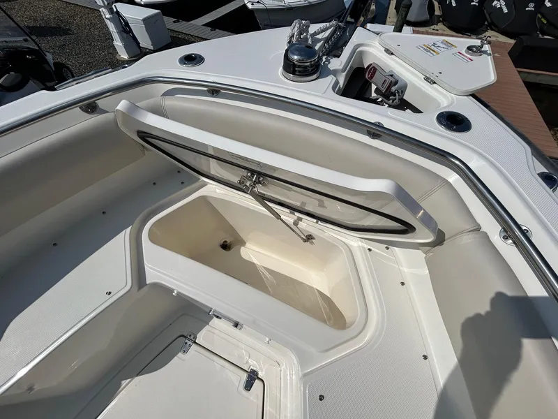 Slide: The Image of 2024 Boston Whaler 230 Outrage boat interior with open storage compartment. - 21