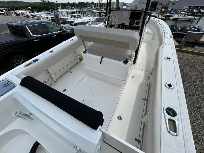 Slide: The Image of 2024 Boston Whaler 230 Outrage boat on display under cloudy sky. - 5