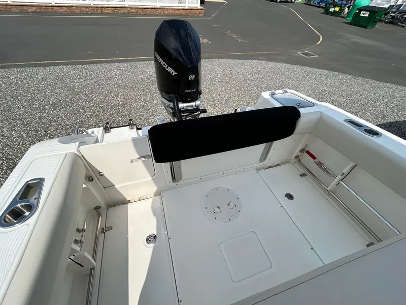 Slide: The Image of 2024 Boston Whaler 230 Outrage boat with Mercury engine on gravel lot. - 7