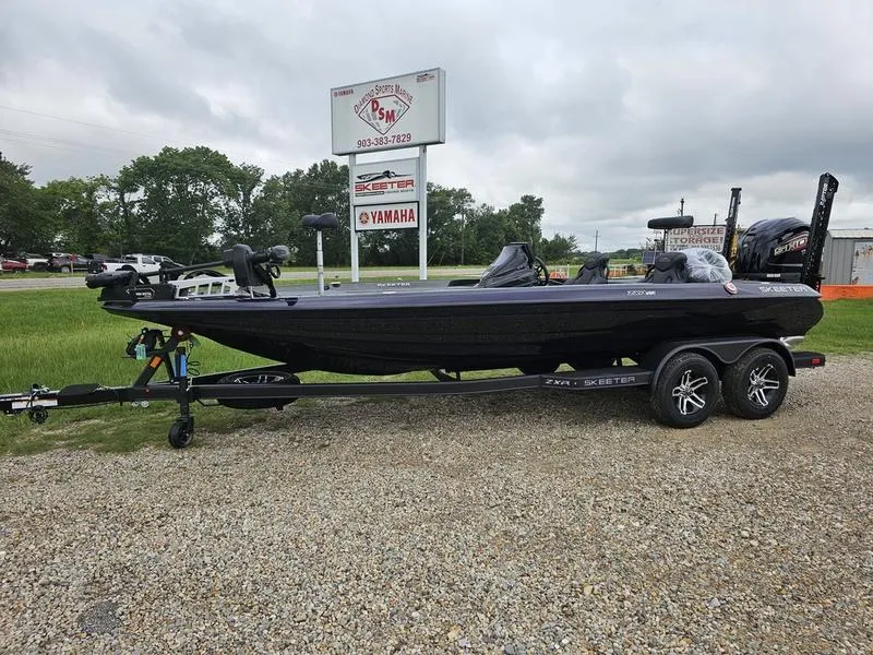 Slide: The Image of 2025 Skeeter ZXR21 bass boat on a trailer in a dealership lot. - 1