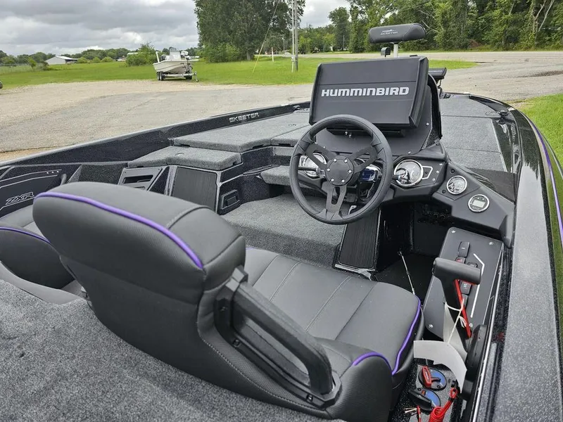 Slide: The Image of 2025 Skeeter ZXR21 boat interior with Humminbird electronics and modern dashboard. - 11
