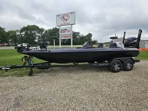 Slide: The Image of 2025 Skeeter ZXR21 bass boat on a trailer in a dealership lot. - 15