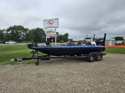 Slide: The Image of 2025 Skeeter ZXR21 boat on a trailer in a dealership lot. - 28
