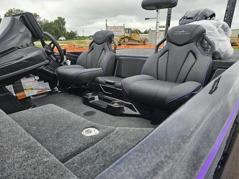 Slide: The Image of 2025 Skeeter ZXR21 boat interior with black seats and modern dashboard. - 6