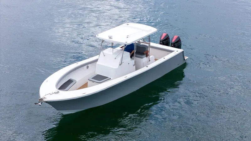 Slide: The Image of 2023 Seahorse 36 CC boat on calm water with dual outboard motors. - 10