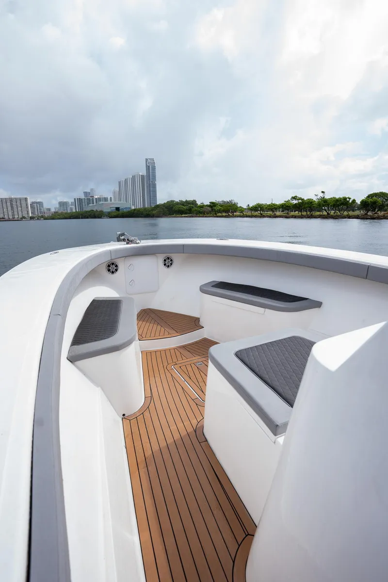 Slide: The Image of 2023 Seahorse 36 CC boat interior with sleek seating and wooden deck. - 12