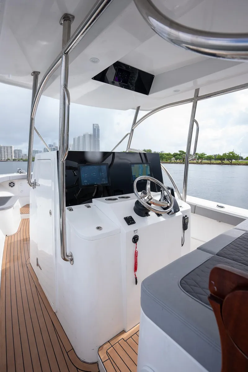 Slide: The Image of 2023 Seahorse 36 CC boat interior with modern helm and wooden deck. - 14