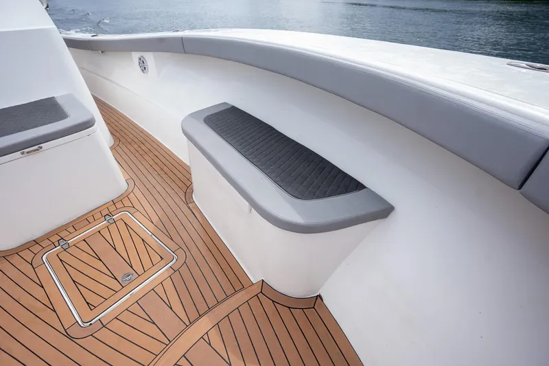 Slide: The Image of 2023 Seahorse 36 CC boat deck with cushioned seating and wood finish. - 24