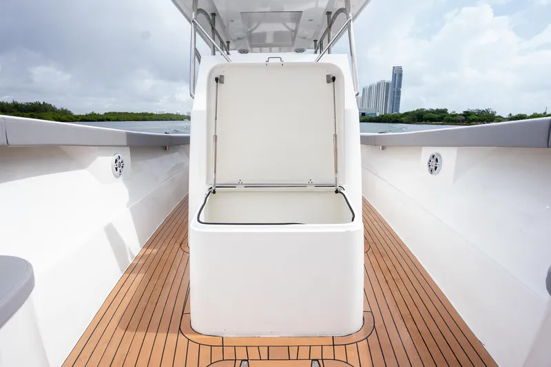 Slide: The Image of 2023 Seahorse 36 CC boat with open storage compartment on teak deck. - 25