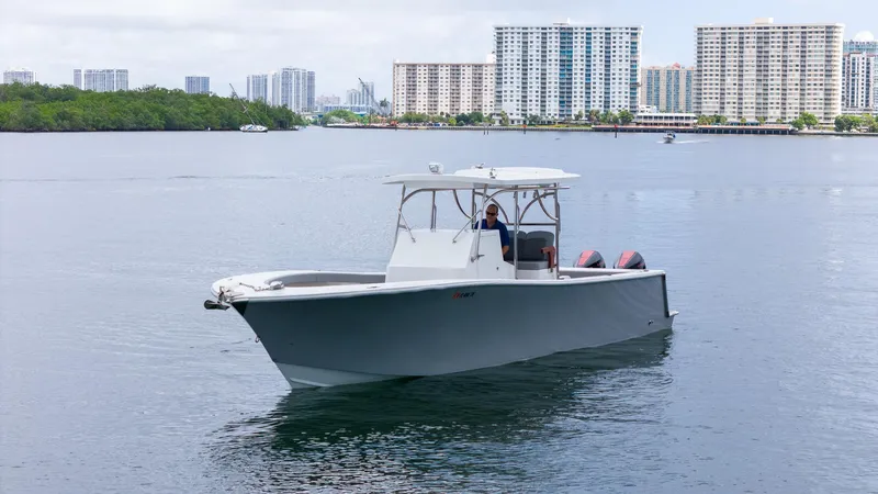 Slide: The Image of 2023 Seahorse 36 CC boat on calm water with city skyline background. - 8