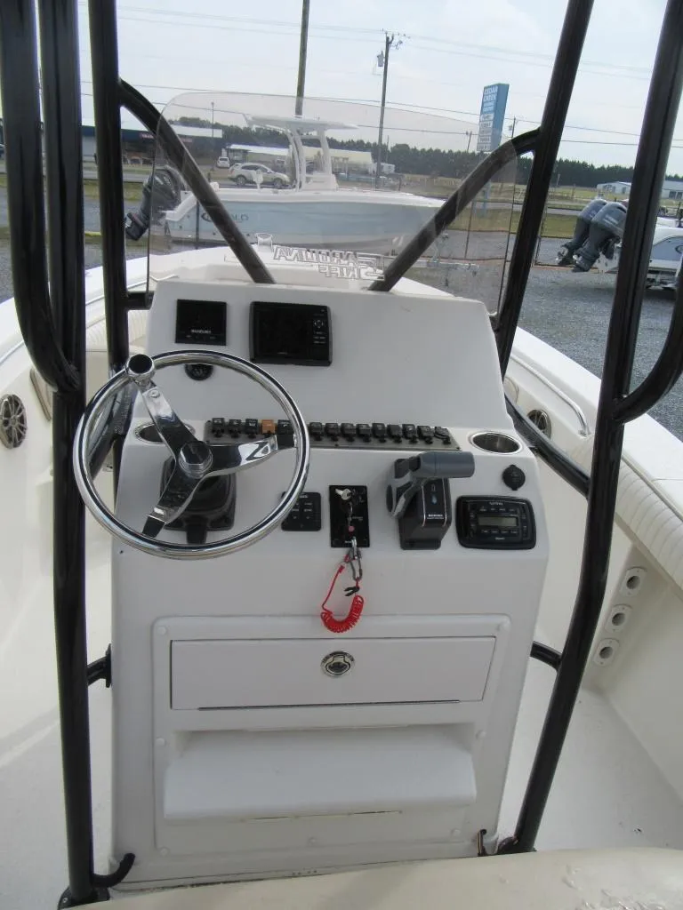 Slide: The Image of 2016 Carolina Skiff Sea Chaser 22 HFC boat console with steering wheel and controls. - 11