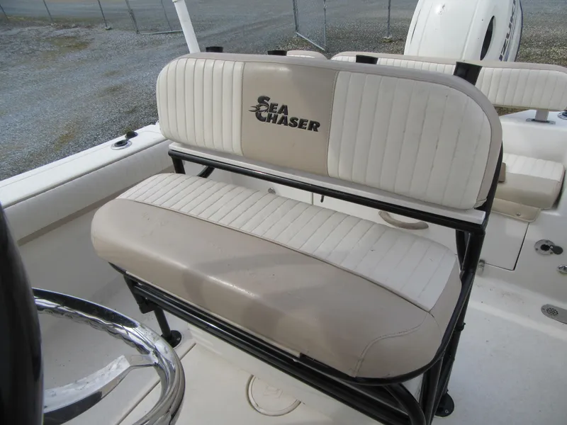 Slide: The Image of 2016 Carolina Skiff Sea Chaser 22 HFC boat seating area with logo. - 12