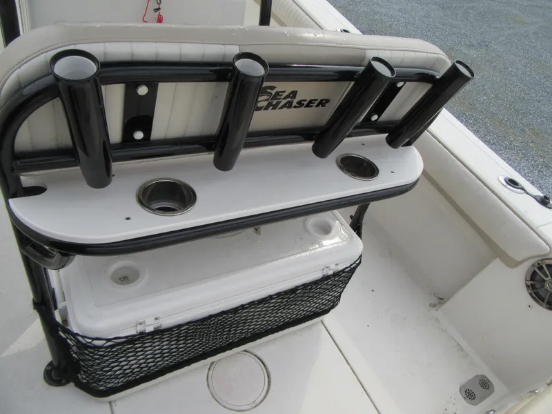 Slide: The Image of 2016 Carolina Skiff Sea Chaser 22 HFC boat with rod holders and storage compartment. - 13