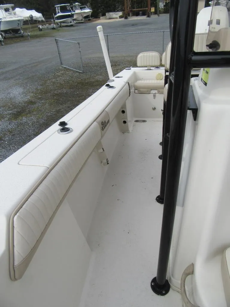 Slide: The Image of 2016 Carolina Skiff Sea Chaser 22 HFC boat interior with seating and rod holders. - 6