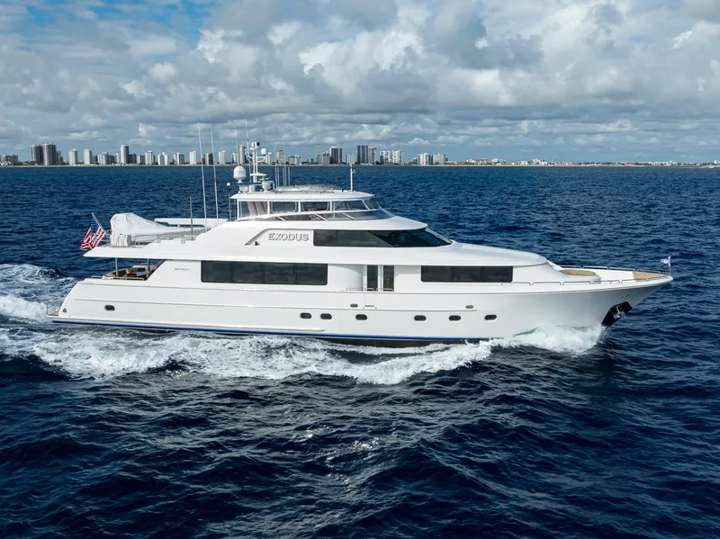 Slide: The Image of Luxury 2008 Westport 112 yacht cruising on open sea with city skyline backdrop. - 0