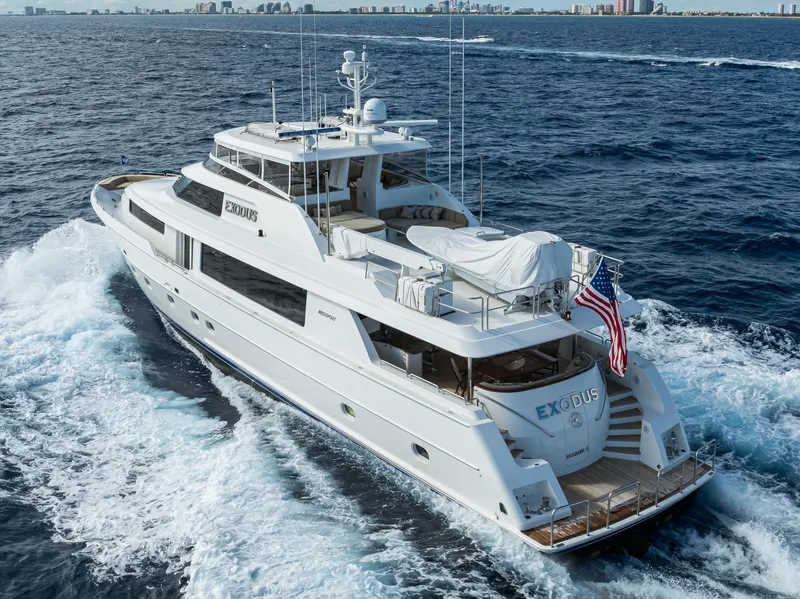 Slide: The Image of Luxurious 2008 Westport 112 yacht cruising on open sea with city skyline in background. - 3