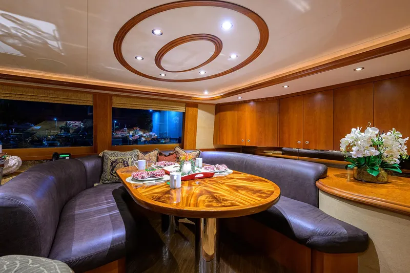 Slide: The Image of Luxurious dining area on 2008 Westport 112 yacht with elegant wood table and plush seating. - 39