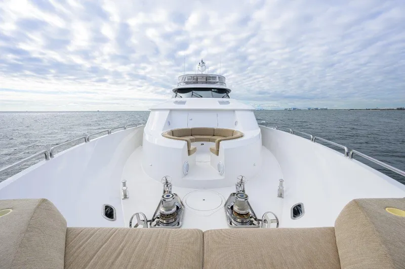 Slide: The Image of Luxurious 2008 Westport 112 yacht cruising on open water under a cloudy sky. - 4