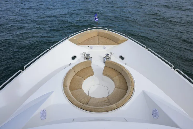 Slide: The Image of Luxurious 2008 Westport 112 yacht bow with circular seating, cruising on open water. - 6