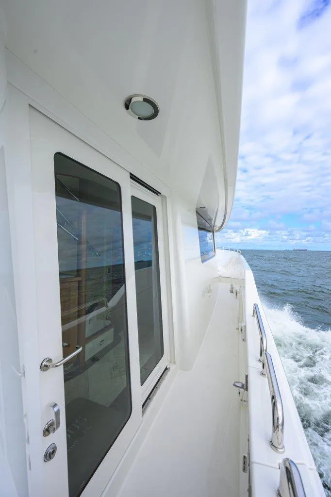 Slide: The Image of Side view of 2008 Westport 112 yacht cruising on open water. - 7