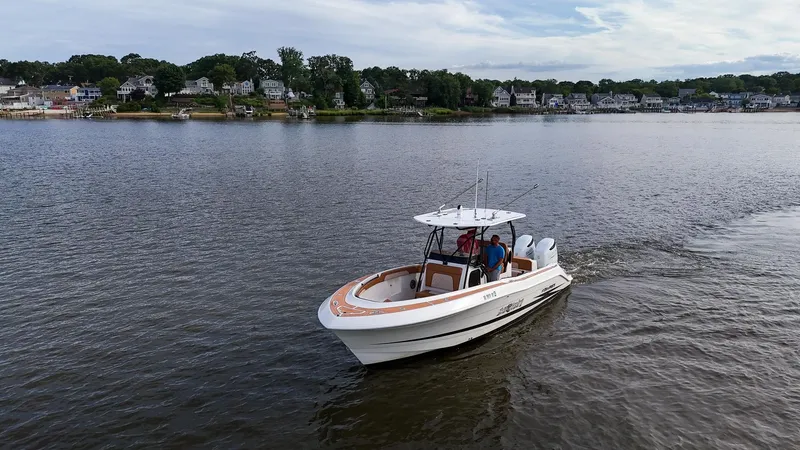Slide: The Image of 2000 Hydra-Sports 2796 Vector boat cruising on a calm lake near residential area. - 12