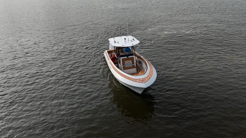 Slide: The Image of 2000 Hydra-Sports 2796 Vector boat cruising on calm waters. - 13