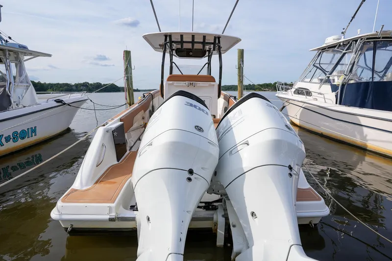 Slide: The Image of 2000 Hydra-Sports 2796 Vector boat with twin outboard engines docked at a marina. - 18