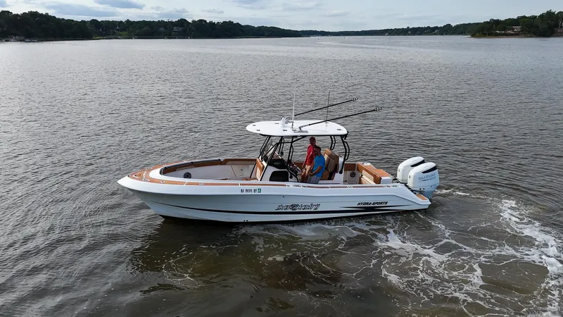 Slide: The Image of 2000 Hydra-Sports 2796 Vector boat cruising on a calm lake. - 2