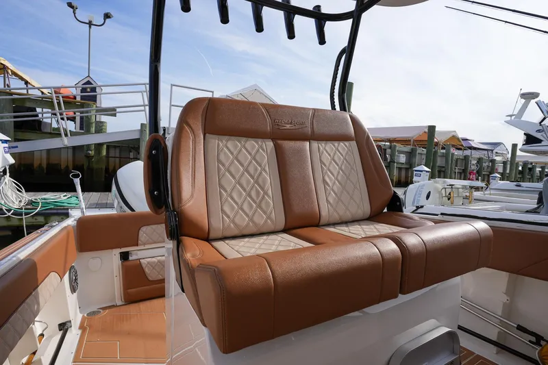 Slide: The Image of 2000 Hydra-Sports 2796 Vector boat with tan and white leather seating at a marina. - 26