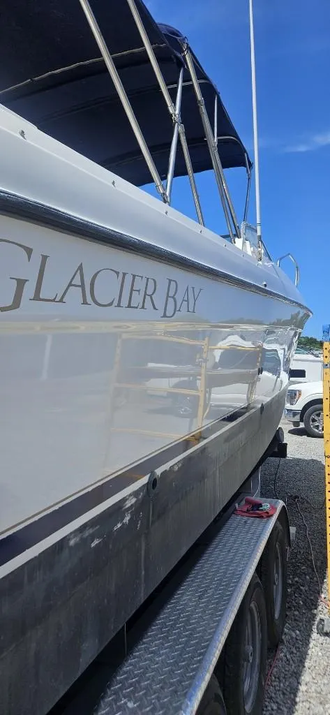 Slide: The Image of 2007 Glacier Bay 2640 Renegade boat on a trailer under a clear blue sky. - 3