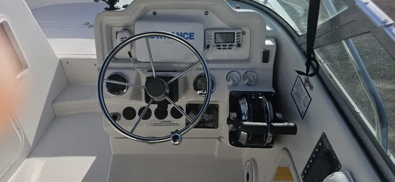 Slide: The Image of 2007 Glacier Bay 2640 Renegade boat helm with steering wheel and control panel. - 6