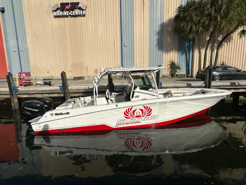 Slide: The Image of 2020 Wellcraft 302 Fisherman boat docked at a marina, featuring a sleek design. - 0