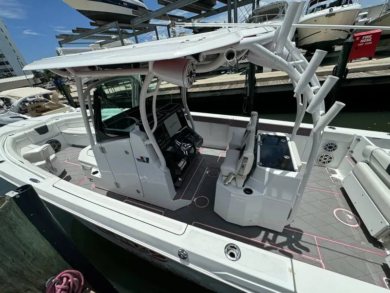 Slide: The Image of 2020 Wellcraft 302 Fisherman boat docked, featuring spacious deck and modern controls. - 16