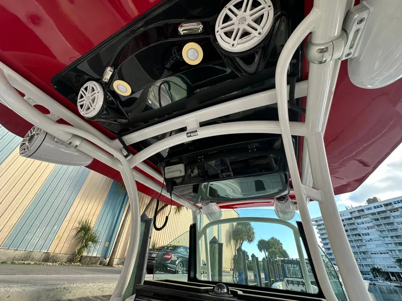 Slide: The Image of 2020 Wellcraft 302 Fisherman boat interior with red canopy and audio system. - 17