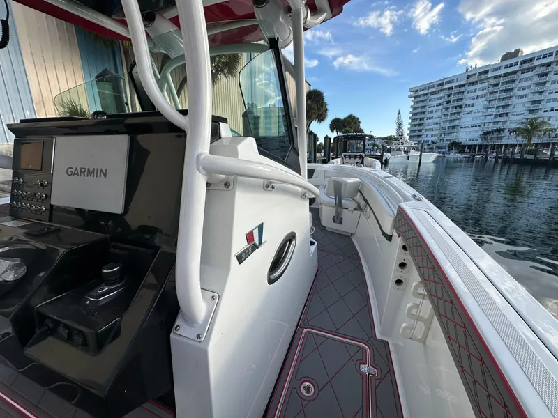 Slide: The Image of 2020 Wellcraft 302 Fisherman boat with Garmin system, docked near waterfront buildings. - 18