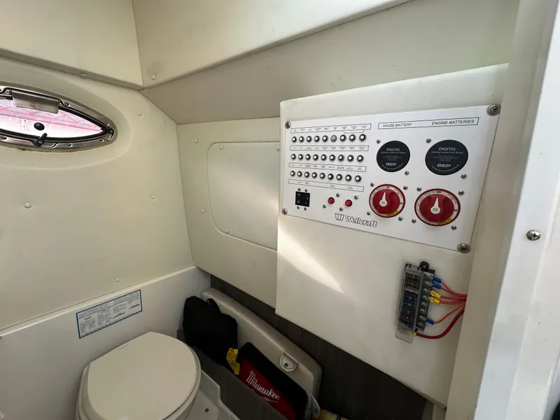 Slide: The Image of 2020 Wellcraft 302 Fisherman boat interior with control panel and toilet. - 19
